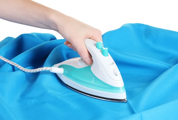 stock image Electric iron on blue cloth isolated on white