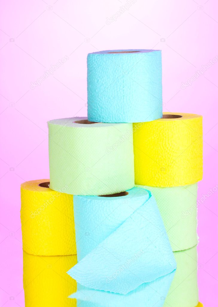 Bright rolls of toilet paper on pink background
