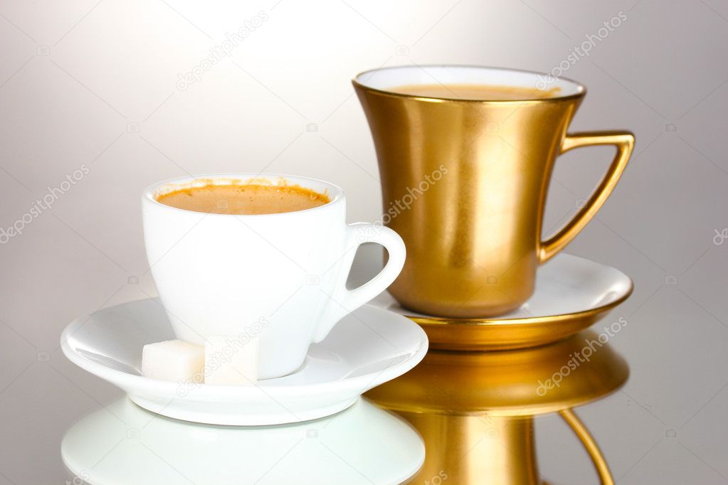 Two cups of coffee and sugar isolated on white