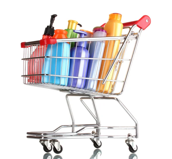 Shopping cart with detergent bottles isolated on white — Stock Photo, Image
