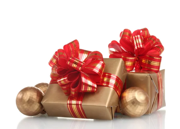 Beautiful golden gifts with red ribbon and Christmas balls isolated on whit — Stock Photo, Image