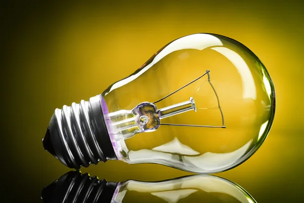 Light bulb on yellow background — Stock Photo, Image