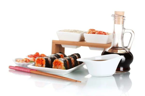 Delicious sushi on plate, chopsticks, soy sauce, fish and shrimps isolated — Stock Photo, Image