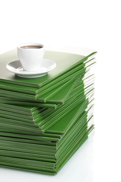 Many green folder with cup of coffee isolated on white — Stock Photo, Image
