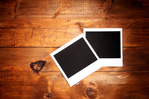 Photo papers on wooden background