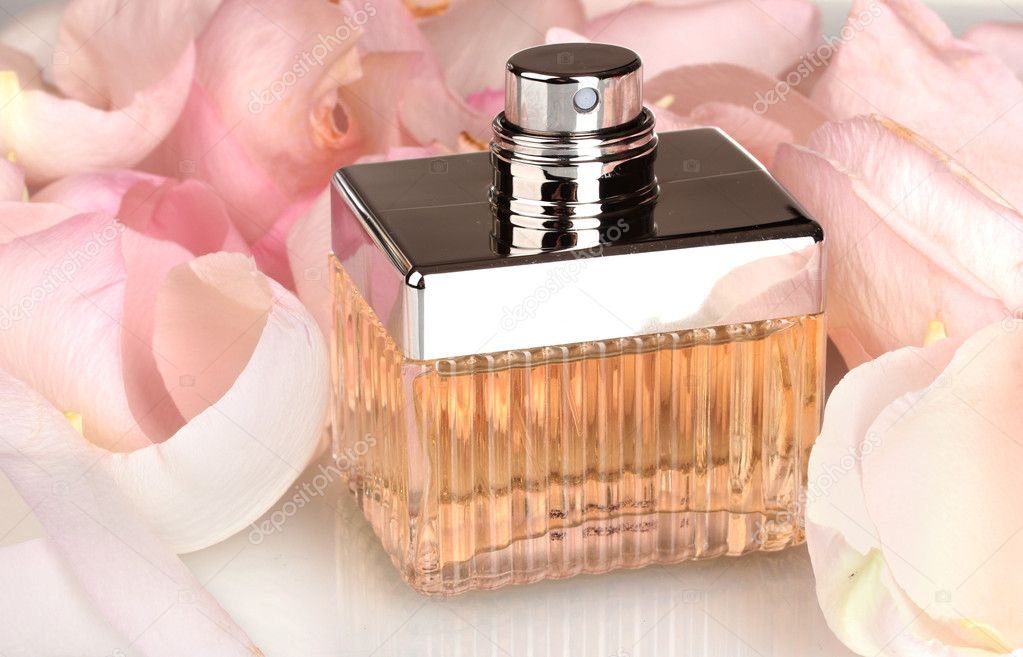 Perfume in a beautiful bottle and petals closeup