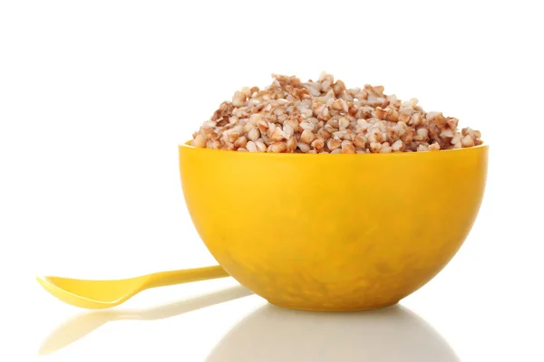 Boiled buckwheat in a yellow bowl isolated on white — Stock Photo, Image