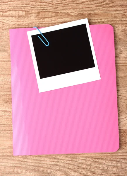 Photo paper and pink notebook on wooden background — Stock Photo, Image