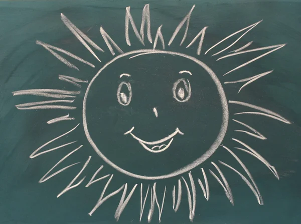 Blackboard with drawing smiling sun closeup — Stock Photo, Image