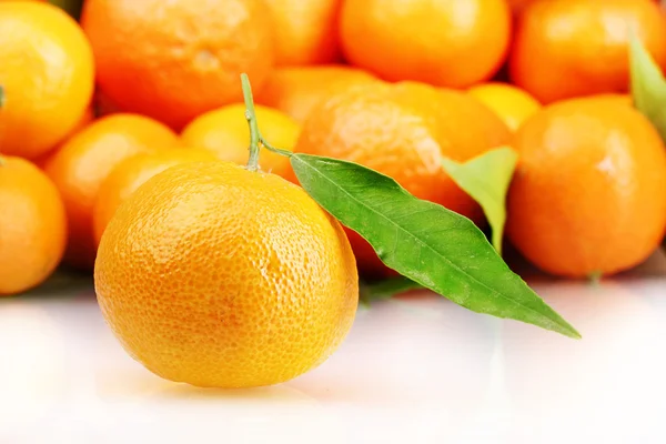 Rijp smakelijke mandarijnen met bladeren close-up — Stockfoto