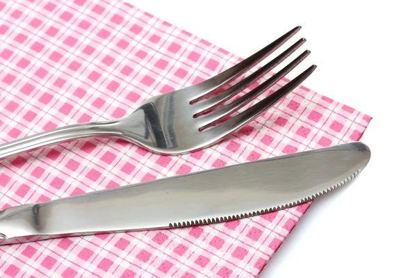 Vidlička a nůž v kostkované látky izolované na bílém — Stock fotografie