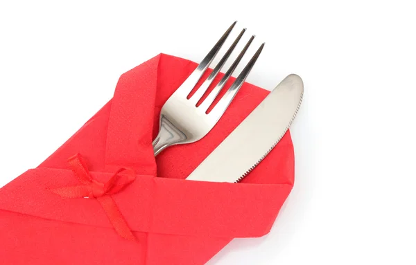 Fork and knife in a red cloth with a bow isolated on white Royalty Free Stock Images