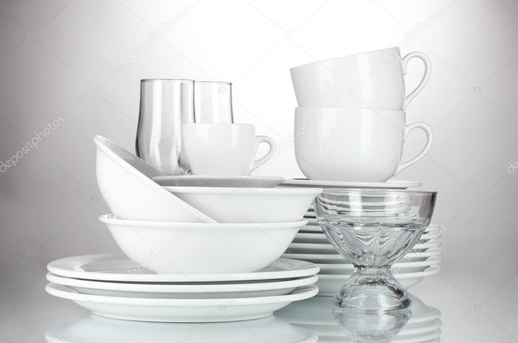 Empty bowls, plates, cups and glasses isolated on white
