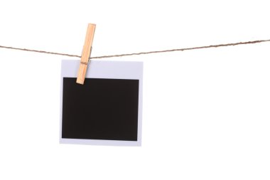 Photo paper hanging on the clothesline isolated on white clipart