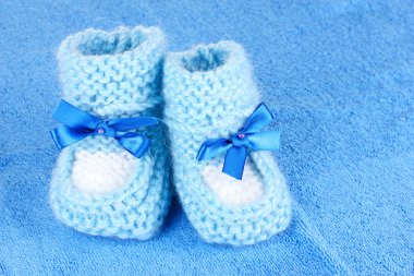 Blue baby booties on blue background