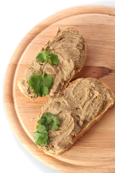 Fresh pate on bread on wooden board — Stock Photo, Image