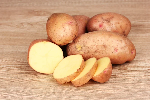 Potatoes on wooden background — Stock Photo, Image