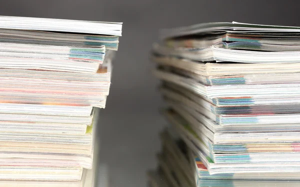 Stacks of magazines on gray background — Stock Photo, Image
