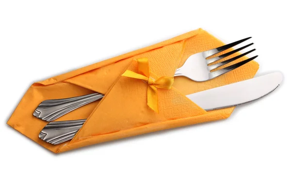 Fork and knife in a yellow cloth with a bow isolated on white — Stock Photo, Image