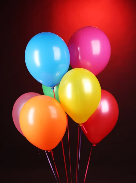Bright balloons on red background — Stock Photo, Image