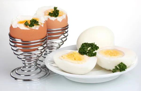 Tasty boiled eggs and parsley isolated on white — Stock Photo, Image