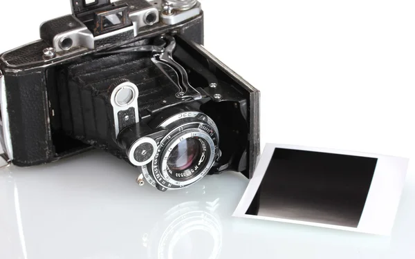 Old photo camera with photo paper isolated on white — Stock Photo, Image