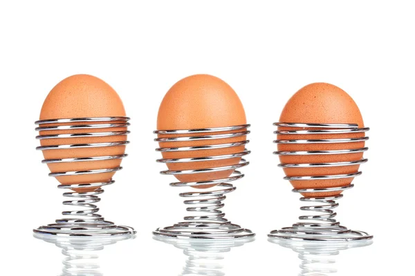 Boiled eggs in metal stands isolated on white — Stock Photo, Image