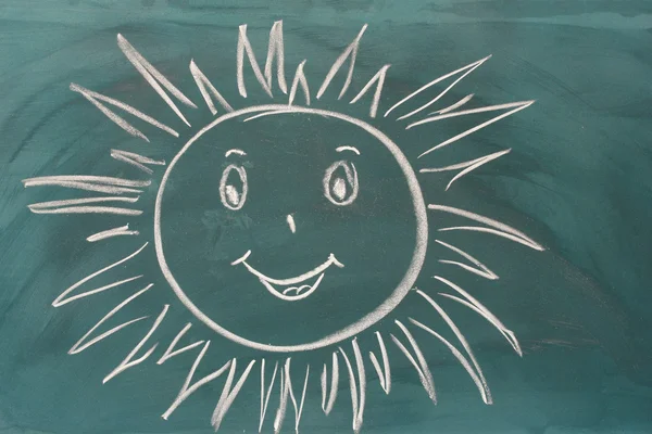 Tableau noir avec dessin souriant soleil gros plan — Photo