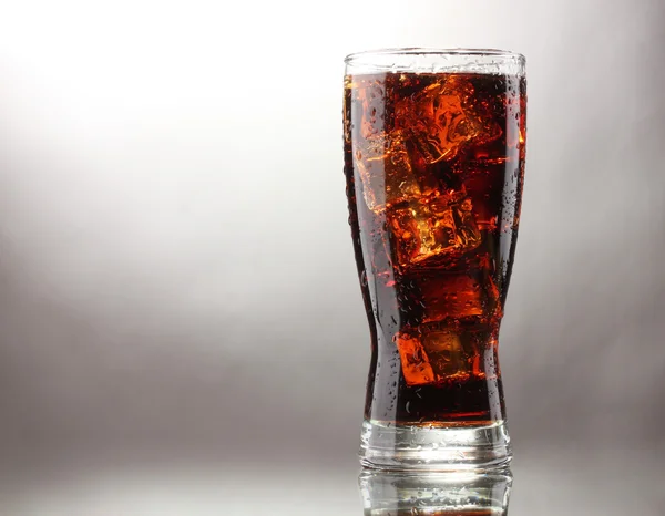 Glass of cola with ice on grey background — Stock Photo, Image