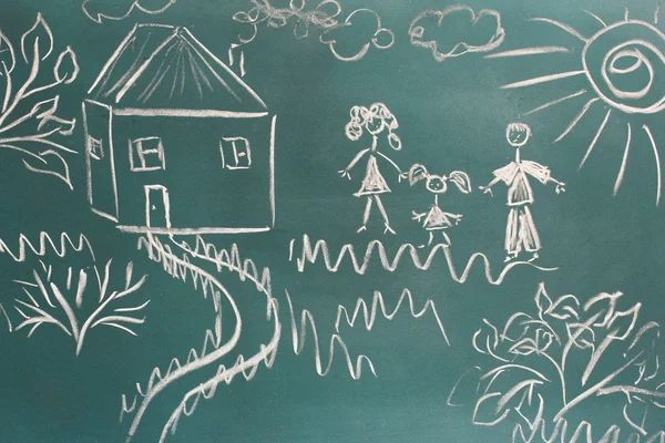 Blackboard with drawing happy family with house closeup — Stock Photo, Image