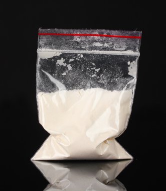 Cocaine in package on black background clipart