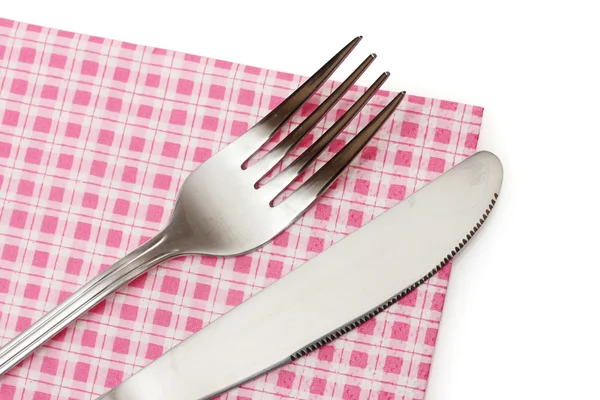 Fork and knife in a plaid cloth isolated on white — Stock Photo, Image