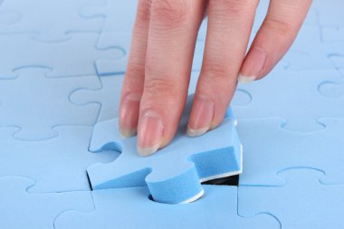 Hand collecting a part of a puzzle clipart