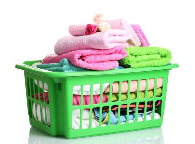 Towels in green plastic basket isolated on white clipart