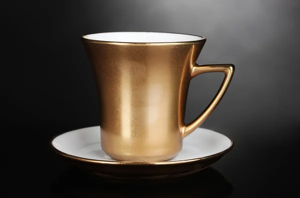 Gyllene kopp kaffe på grå bakgrund — Stockfoto