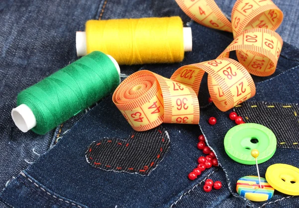 Hart-vormige patch op jeans met draden en knoppen close-up — Stockfoto