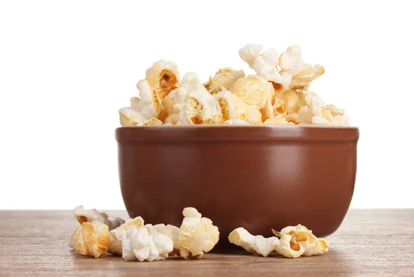 Popcorn in brown bowl on wooden table on white background — Stock Photo, Image