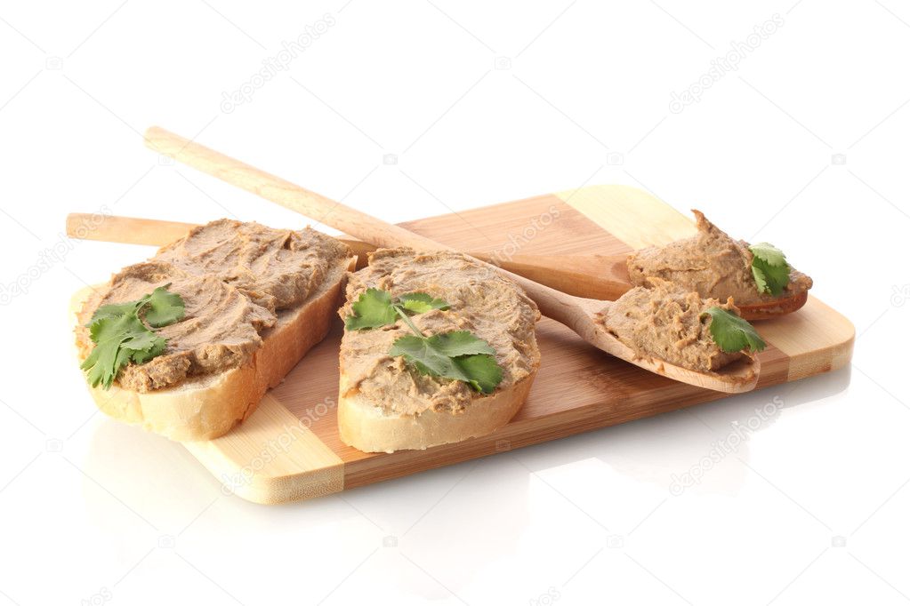 Fresh pate on bread on wooden board isolated on white