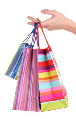 Bright gift bags in hand isolated on white clipart