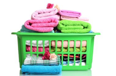 Towels in green plastic basket isolated on white clipart