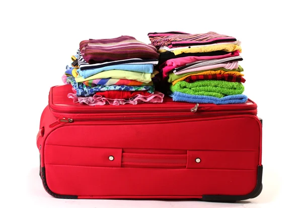 Сlosed red suitcase with clothing isolated on white — Stock Photo, Image