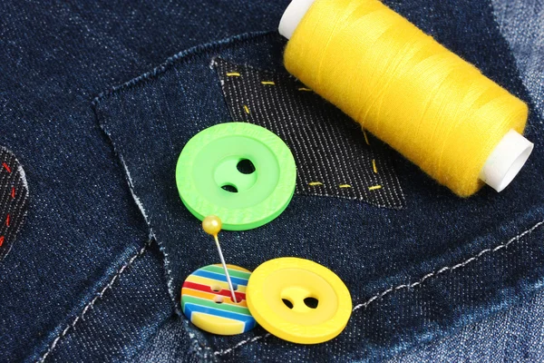 Rhomb-shaped patch on jeans with threads and buttons closeup — Stock Photo, Image