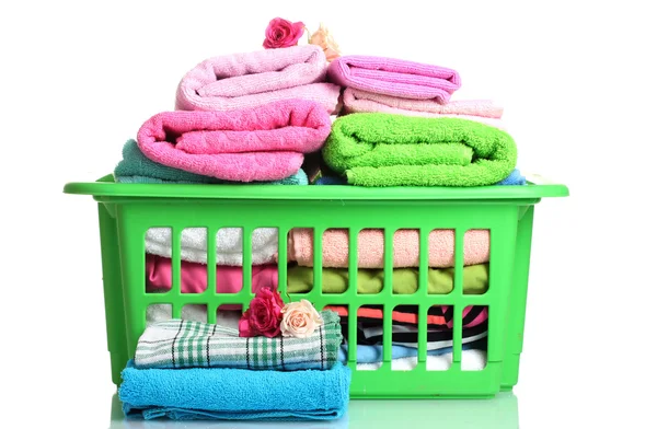 stock image Towels in green plastic basket isolated on white