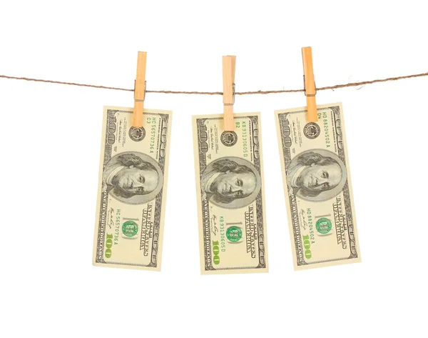 Three one hundred dollar bills is hanging on a rope with wooden clothespin — Stock Photo, Image