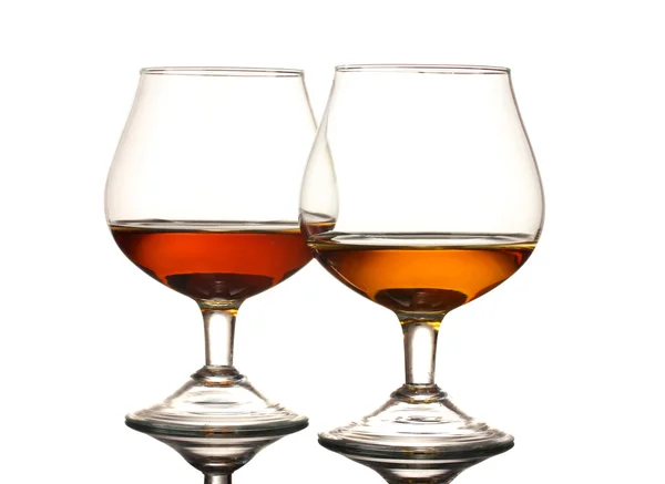 Two glasses of cognac on grey background — Stock Photo, Image