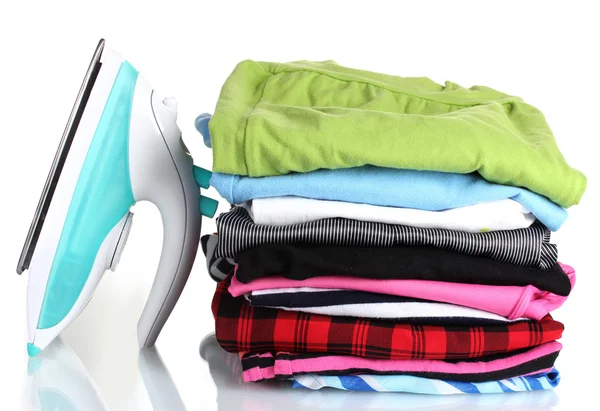 Montón de ropa colorida y plancha eléctrica aislada en blanco —  Fotos de Stock