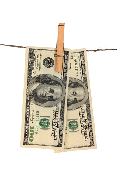 Two one hundred dollar bills is hanging on a rope with wooden clothespin is — Stock Photo, Image