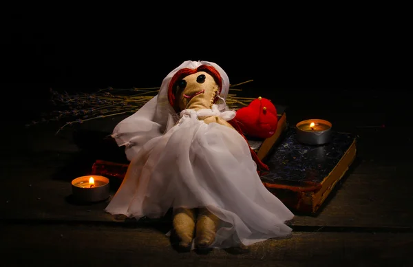 Voodoo panenku dívka nevěsta na dřevěný stůl ve světle svíček — Stock fotografie