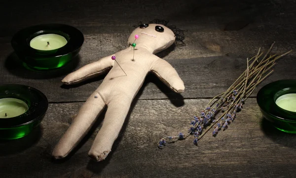 Voodoo doll boy on a wooden table in the candlelight — Stock Photo, Image