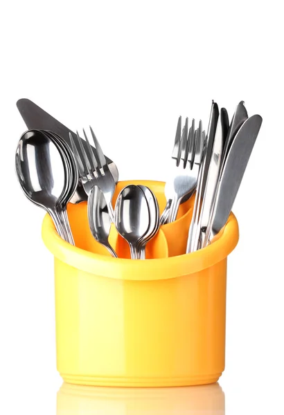 Talheres de cozinha, facas, garfos e colheres em amarelo stand isolado em branco — Fotografia de Stock